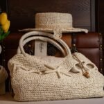Stylish straw bag and hat paired with vintage luggage for a classic rustic look.
